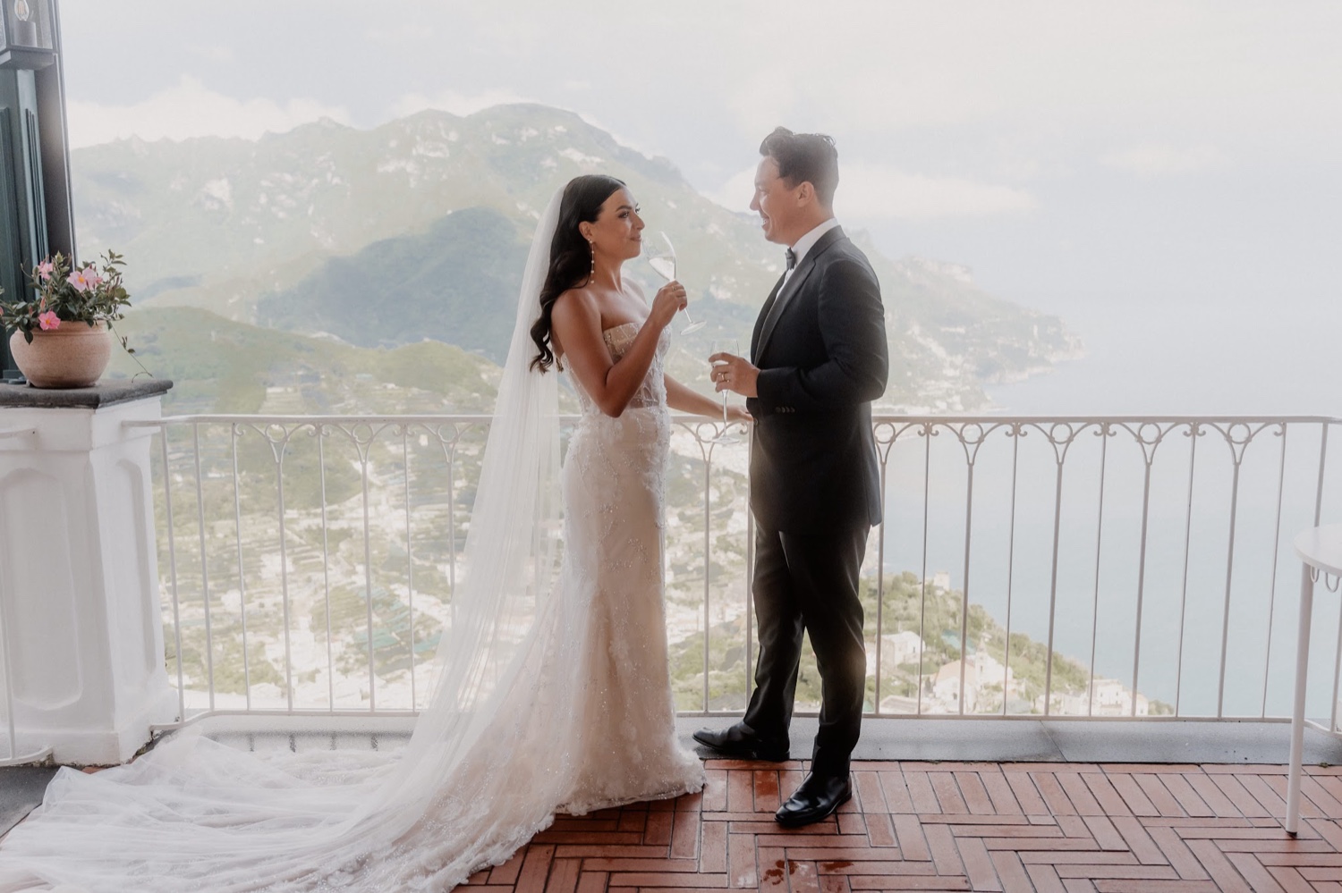 A couple reading their vows on the terrace of Palazzo Avino in Ravello, with the Amalfi Coast below