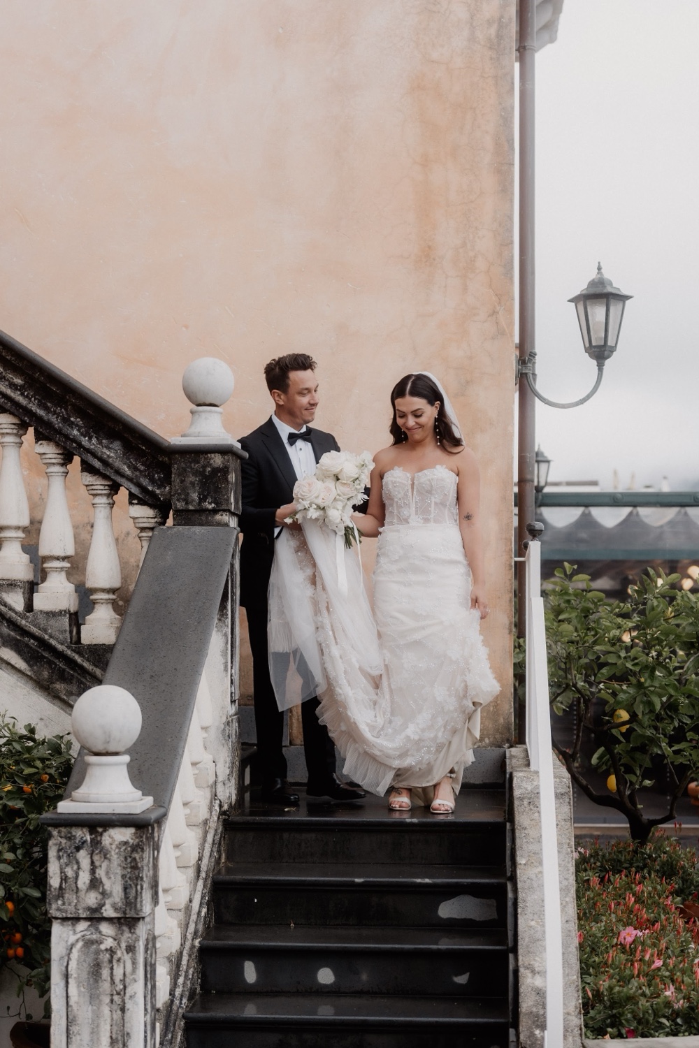 A couple walking down the stone steps of Palazzo Avino in Ravello