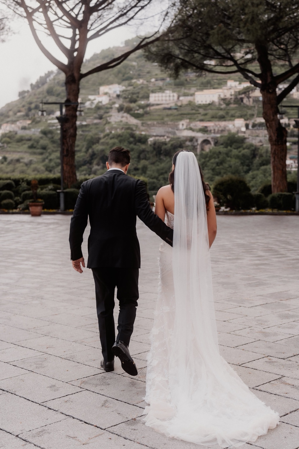 A couple walking hand in hand across the square in Ravello