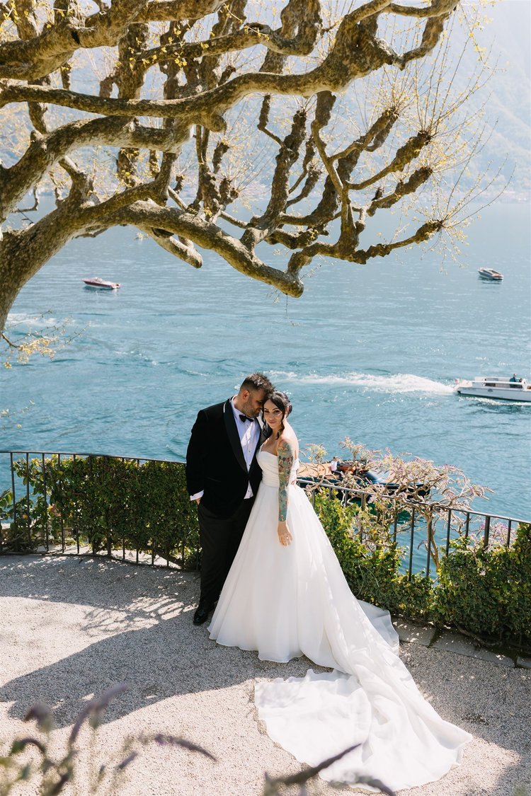 A kiss beneath the branches, above the lake