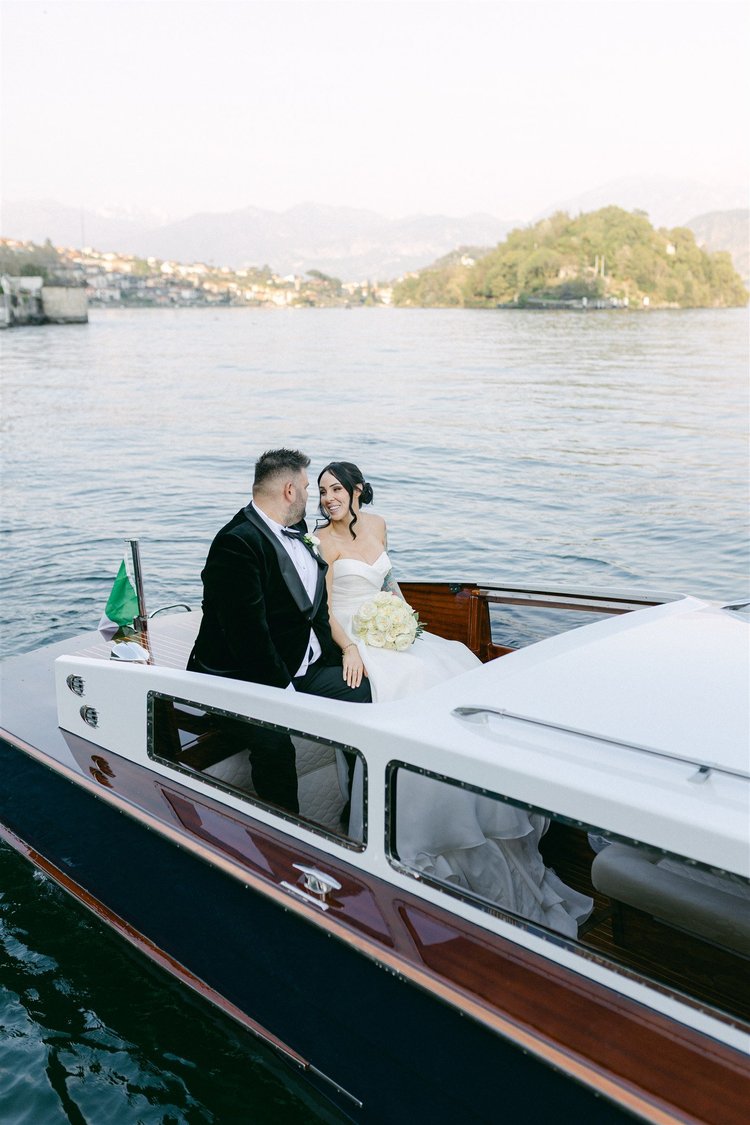 A couple on a wooden boat on Lake Como