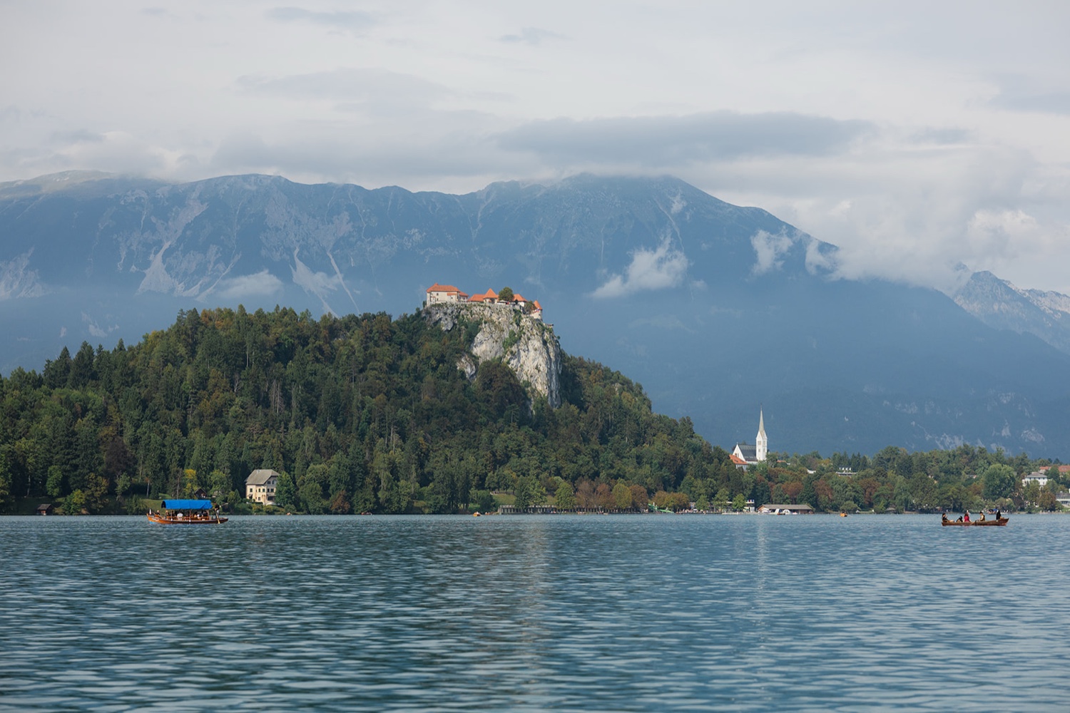 Bled Castle on its cliff above Lake Bled, seen from the water, Slovenia