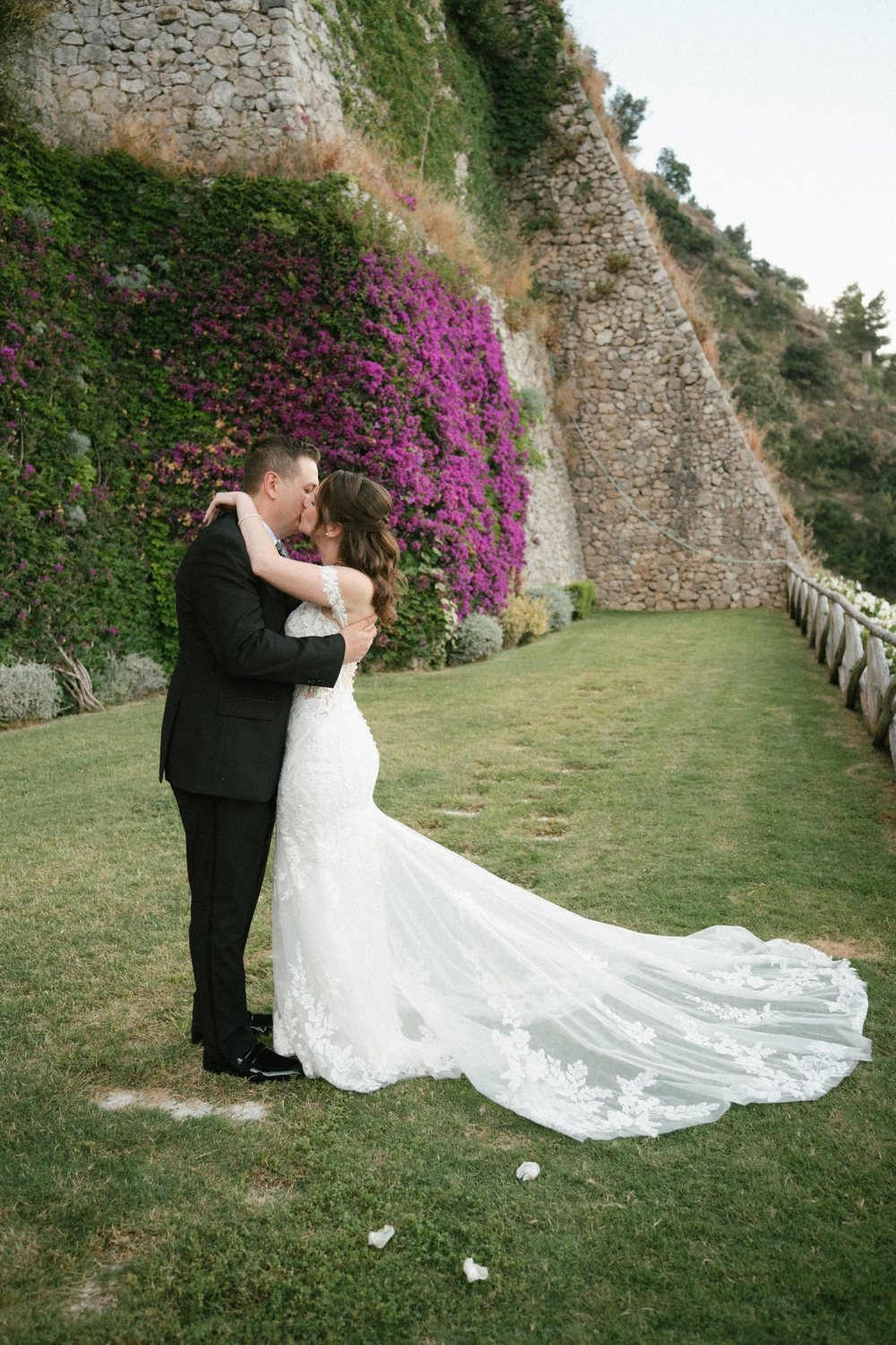 A kiss in the garden, with bougainvillea on the cliff behind