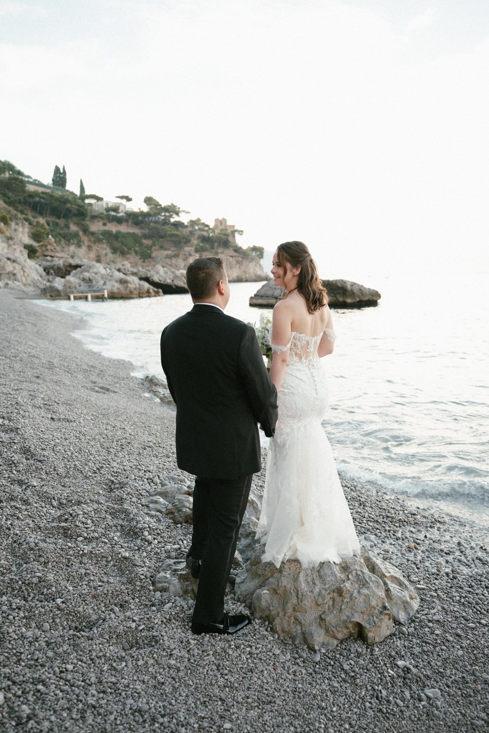 A couple on the pebble beach below Borgo Santandrea on the Amalfi Coast