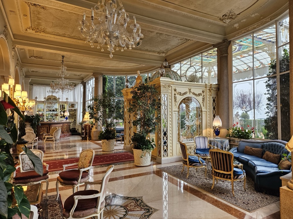 The lounge with a stained-glass roof and crystal chandeliers at the Grand Hotel des Iles Borromées in Stresa, Italy