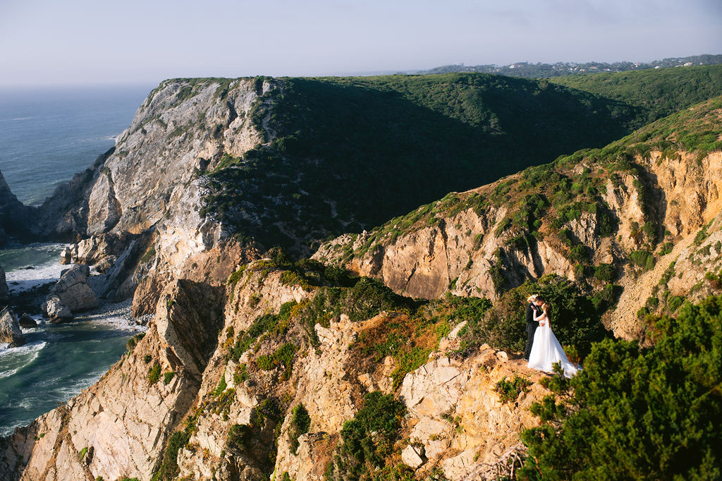 A bride on the green cliffs above the Atlantic at Cabo da Roca in Sintra, Portugal