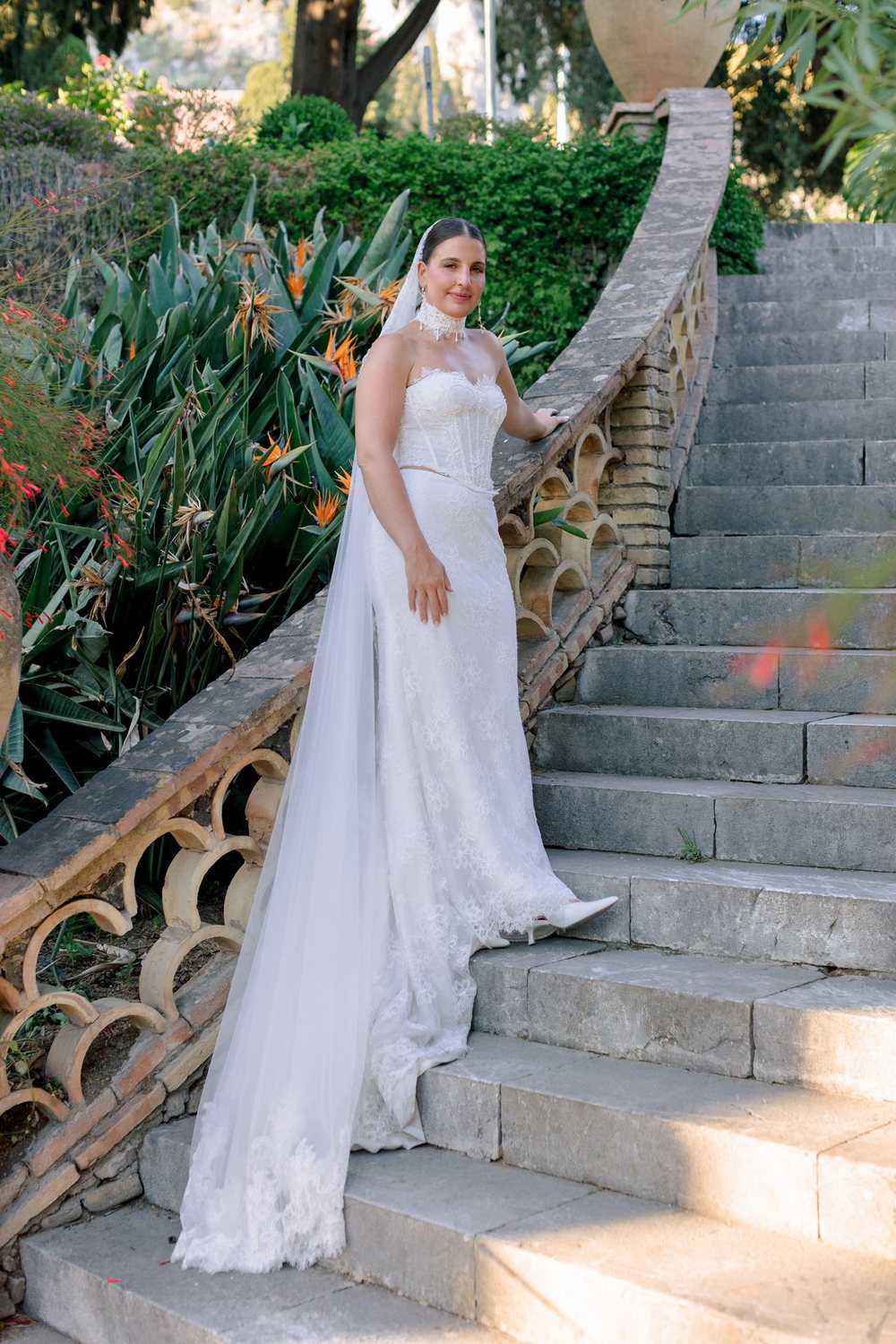 A bride on a garden staircase in Taormina