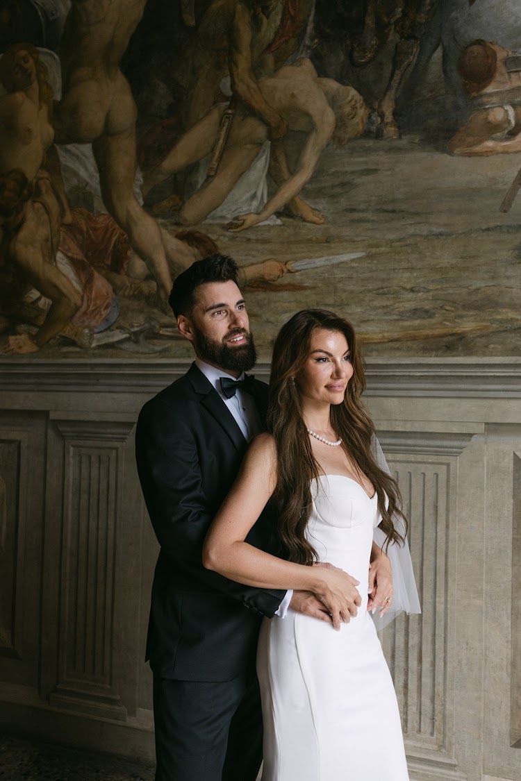 A couple beneath the painted ceilings of the villa