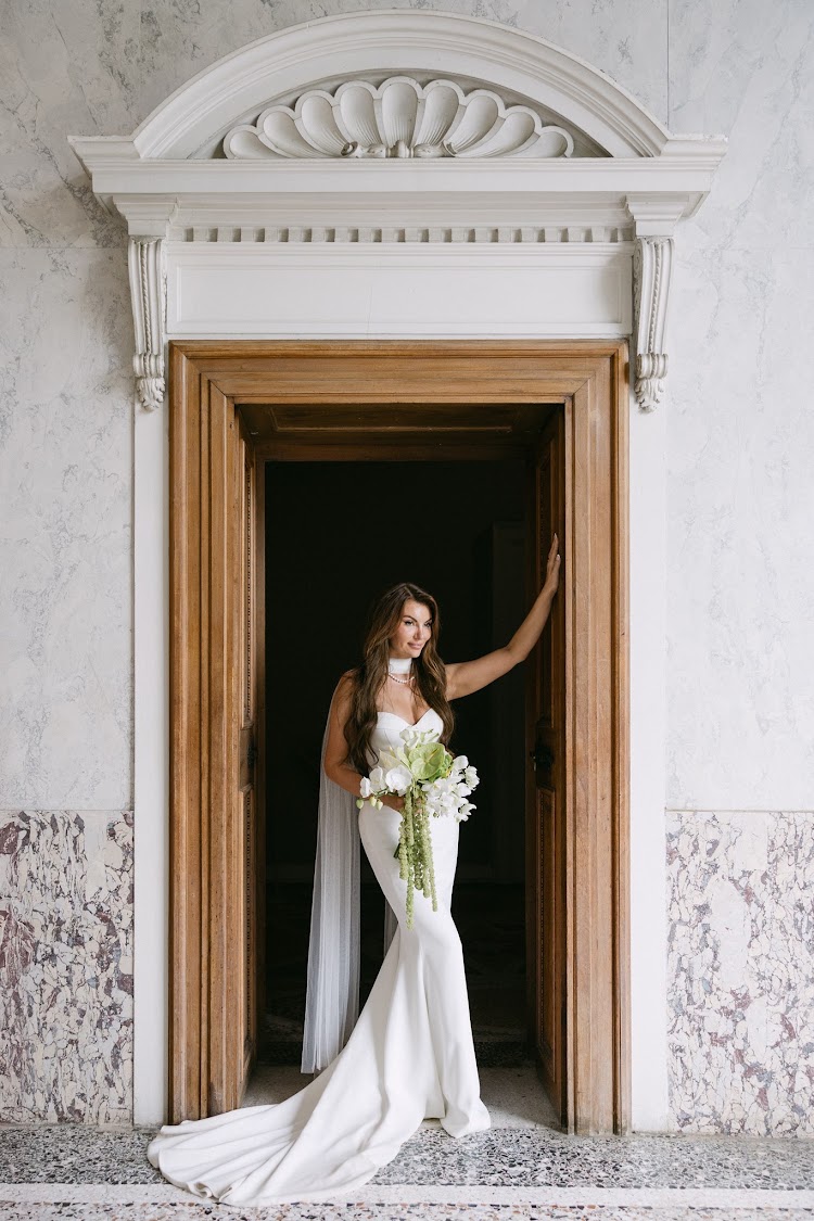 A bride in a carved marble doorway