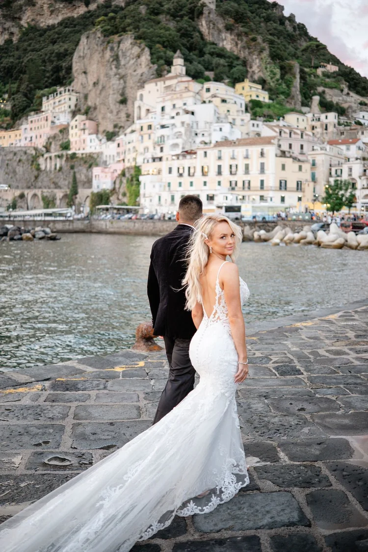 A couple in front of the town of Amalfi