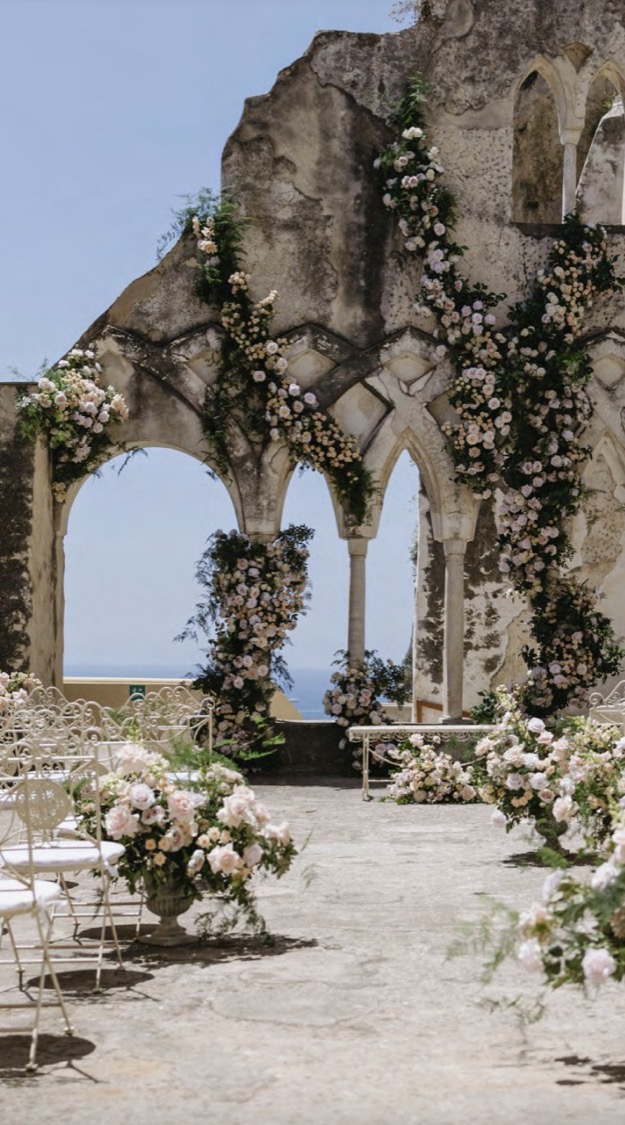 A floral ceremony arch in the cloister of the Anantara Convento di Amalfi