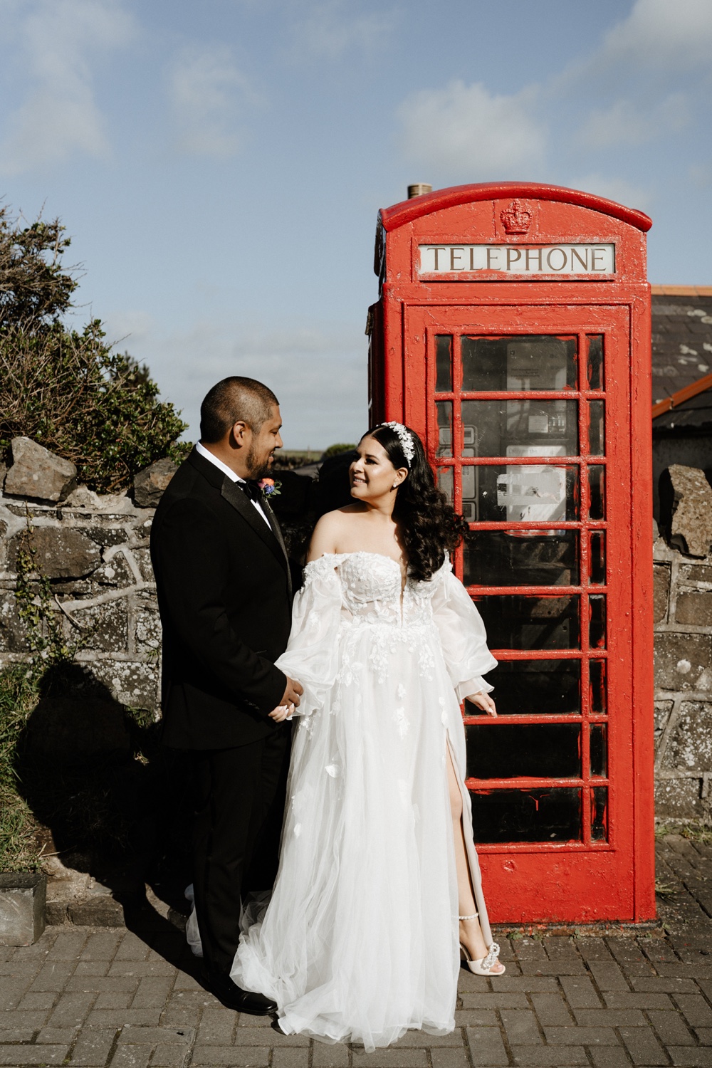 A couple beside a red telephone box on the north coast of Northern Ireland