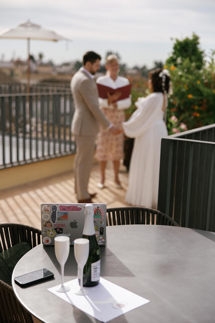 An elopement ceremony with a celebrant on the terrace of EME Catedral Mercer in Seville, overlooking the Cathedral