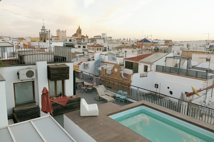 Rooftop terrace with plunge pool and Seville skyline at EME Catedral Mercer hotel in Seville