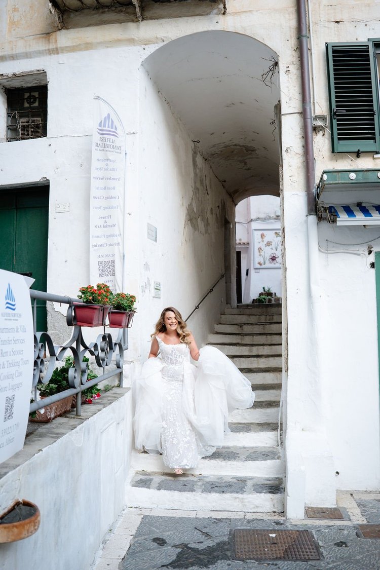 A bride on the whitewashed steps in the centre of Ravello