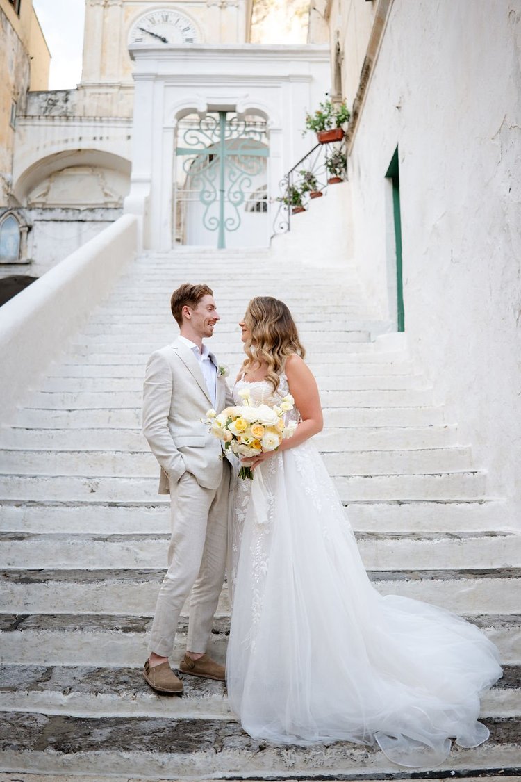 A couple on white stone stairs in the centre of Ravello