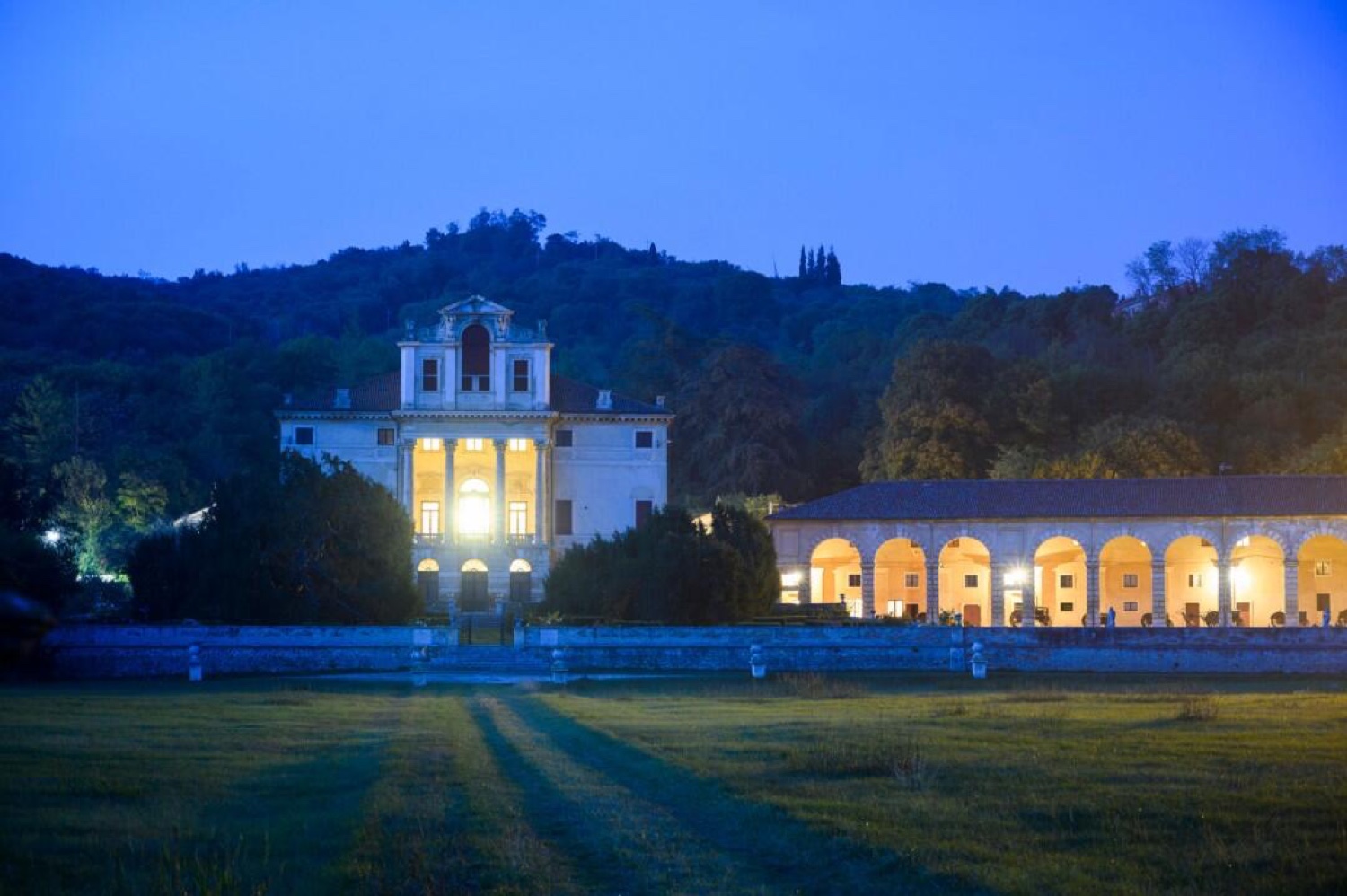 Villa Fracanzan Piovene lit at dusk, with its arcade glowing in the evening near Verona
