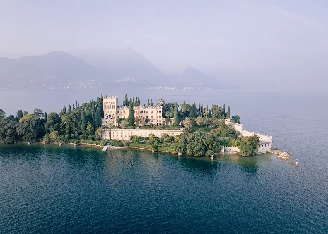 Isola del Garda seen from the air, its villa and cypresses surrounded by the lake