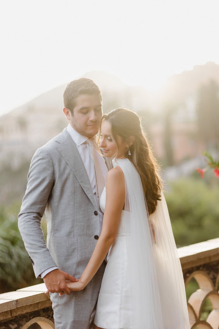 A couple embracing in warm golden light during their elopement in Sicily