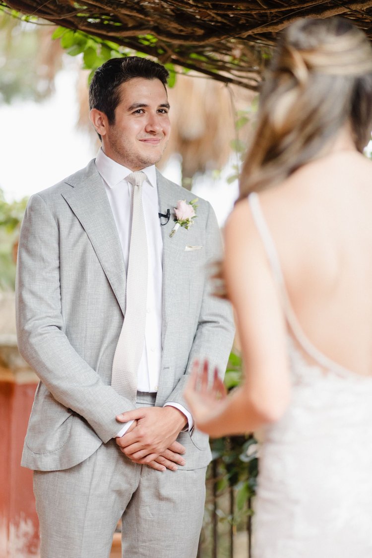 A groom standing beside his bride in soft light during their elopement in Sicily