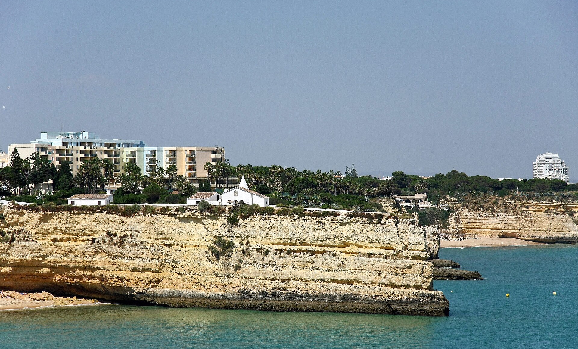 Lady of the Rock chapel on its flat-topped headland above the sea on the Algarve coast, Portugal