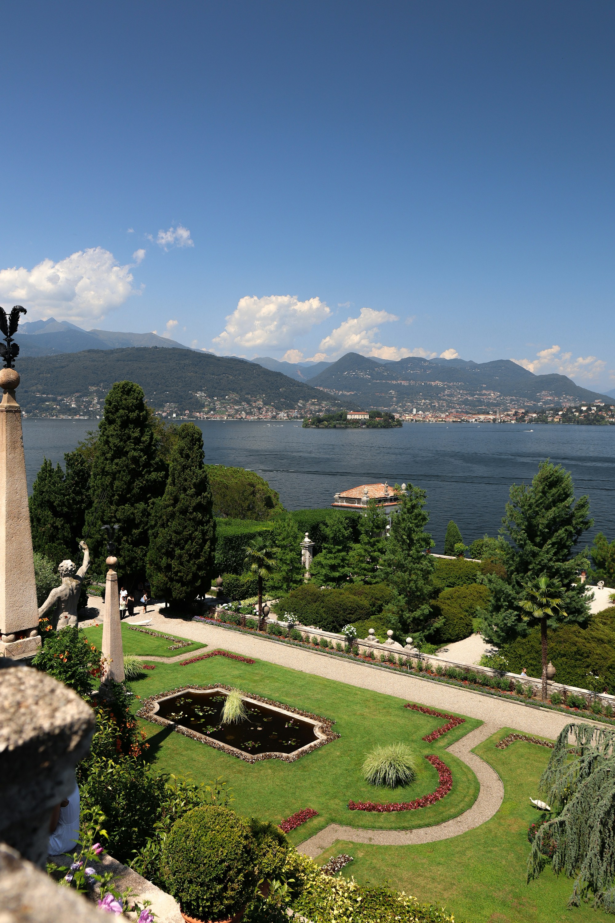 A lakeside garden with cypress trees and a view over Lake Maggiore, Italy