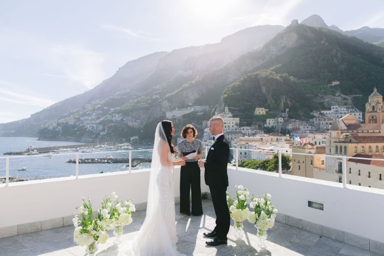 Ceremony setup on the rooftop terrace of Hotel Marina Riviera on the Amalfi Coast, with white chairs, flowers and views over Amalfi