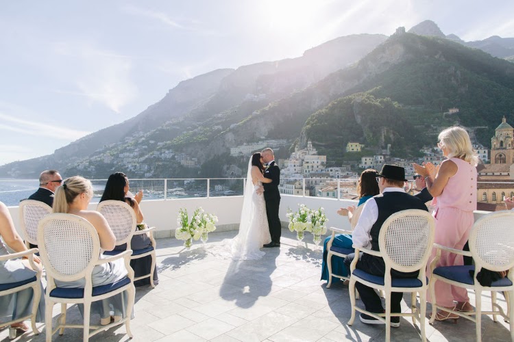 Guests seated on the rooftop terrace of Hotel Marina Riviera on the Amalfi Coast watching an elopement ceremony with Amalfi Coast mountain views