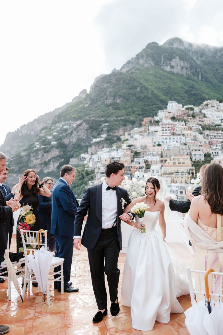 Walking back down the aisle with guests on the terrace
