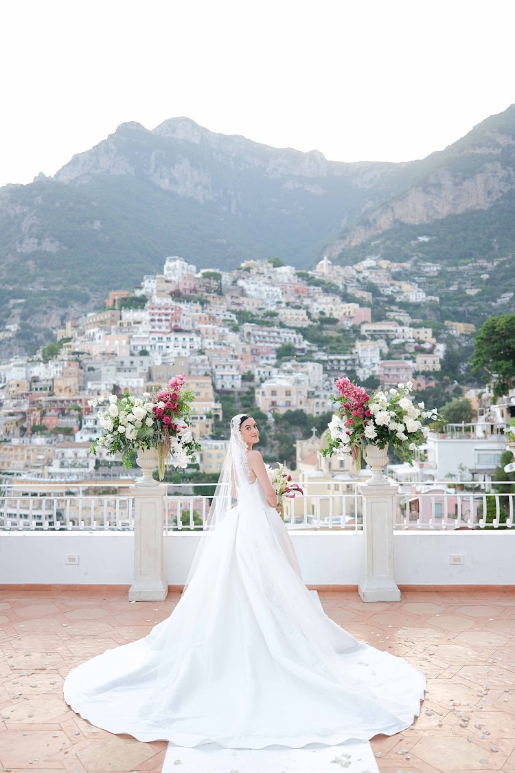 A bride on the terrace, with Positano below