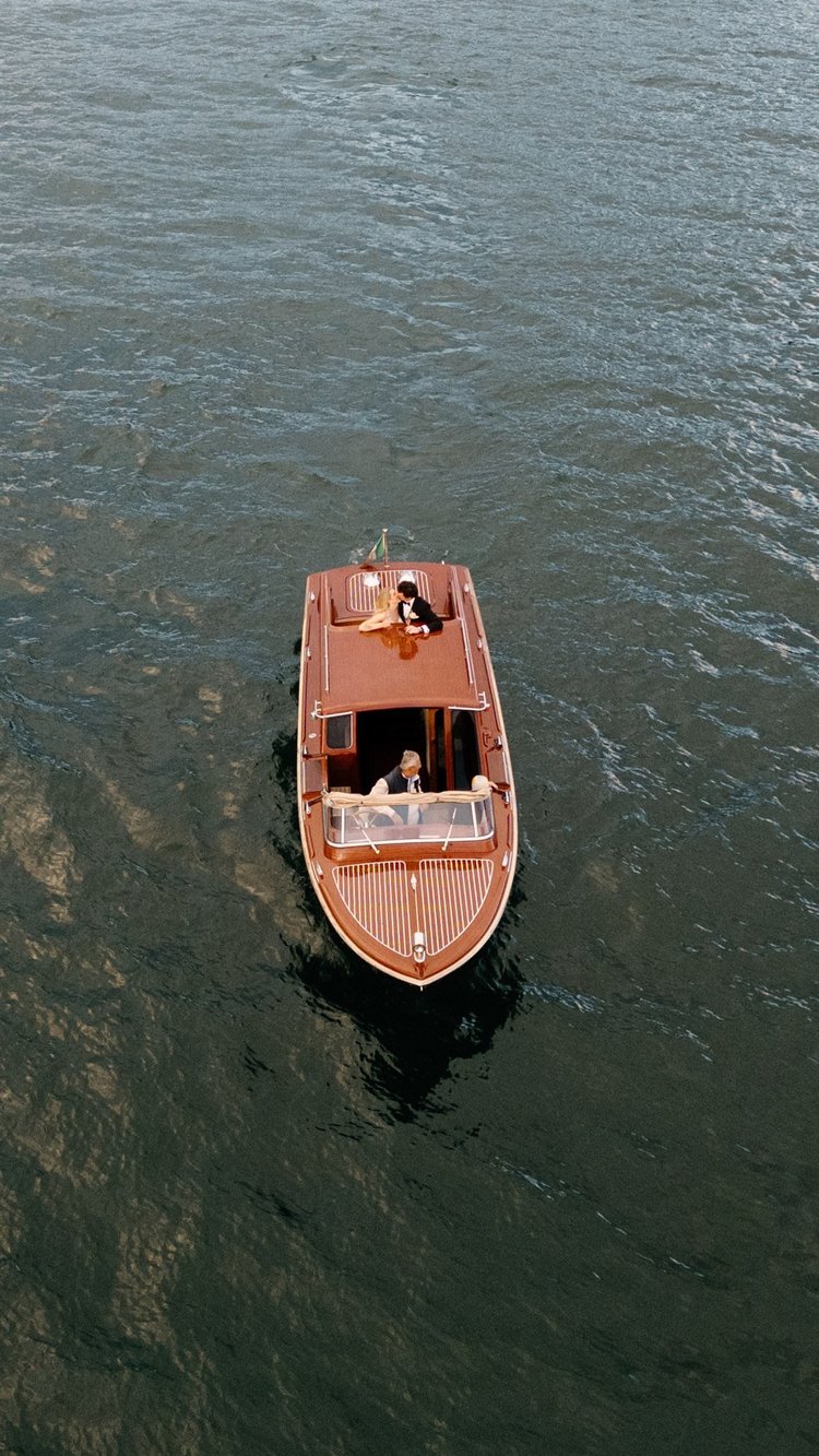 A wooden boat on the lake from above