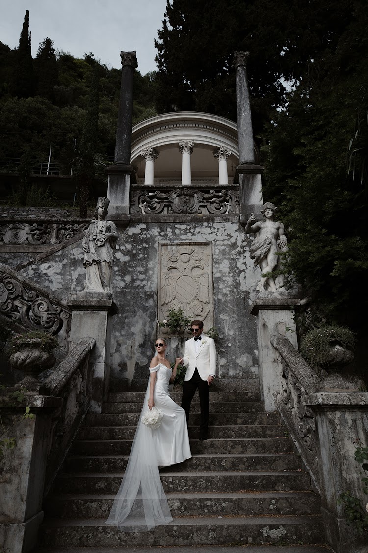 A couple on the garden steps below a small temple