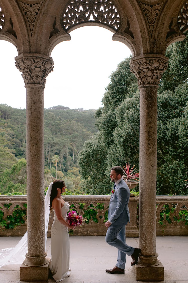 A couple kissing at the foot of the arcaded stairs at Monserrate Palace in Sintra, Portugal