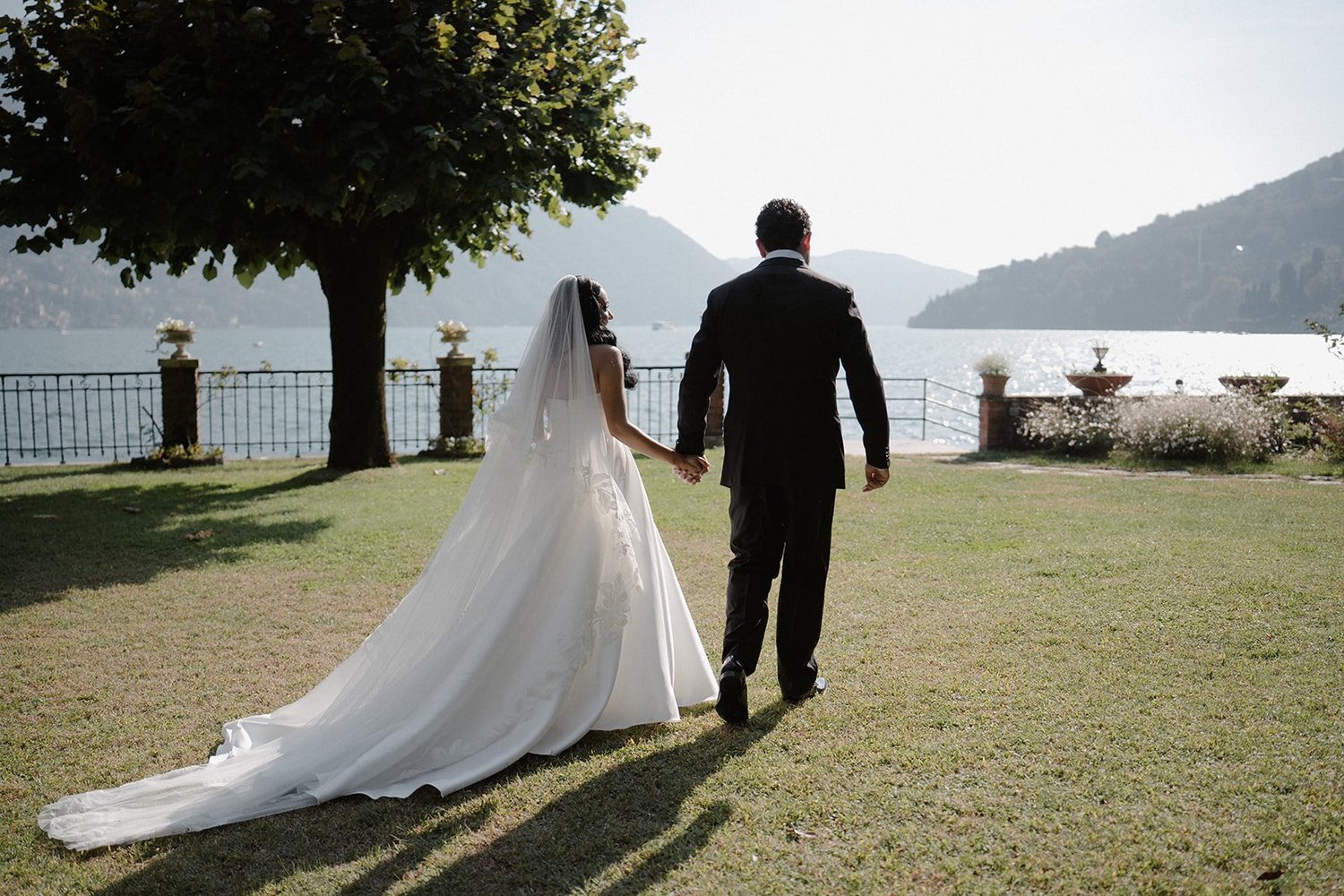 A couple walking towards the lake at Villa Noseda