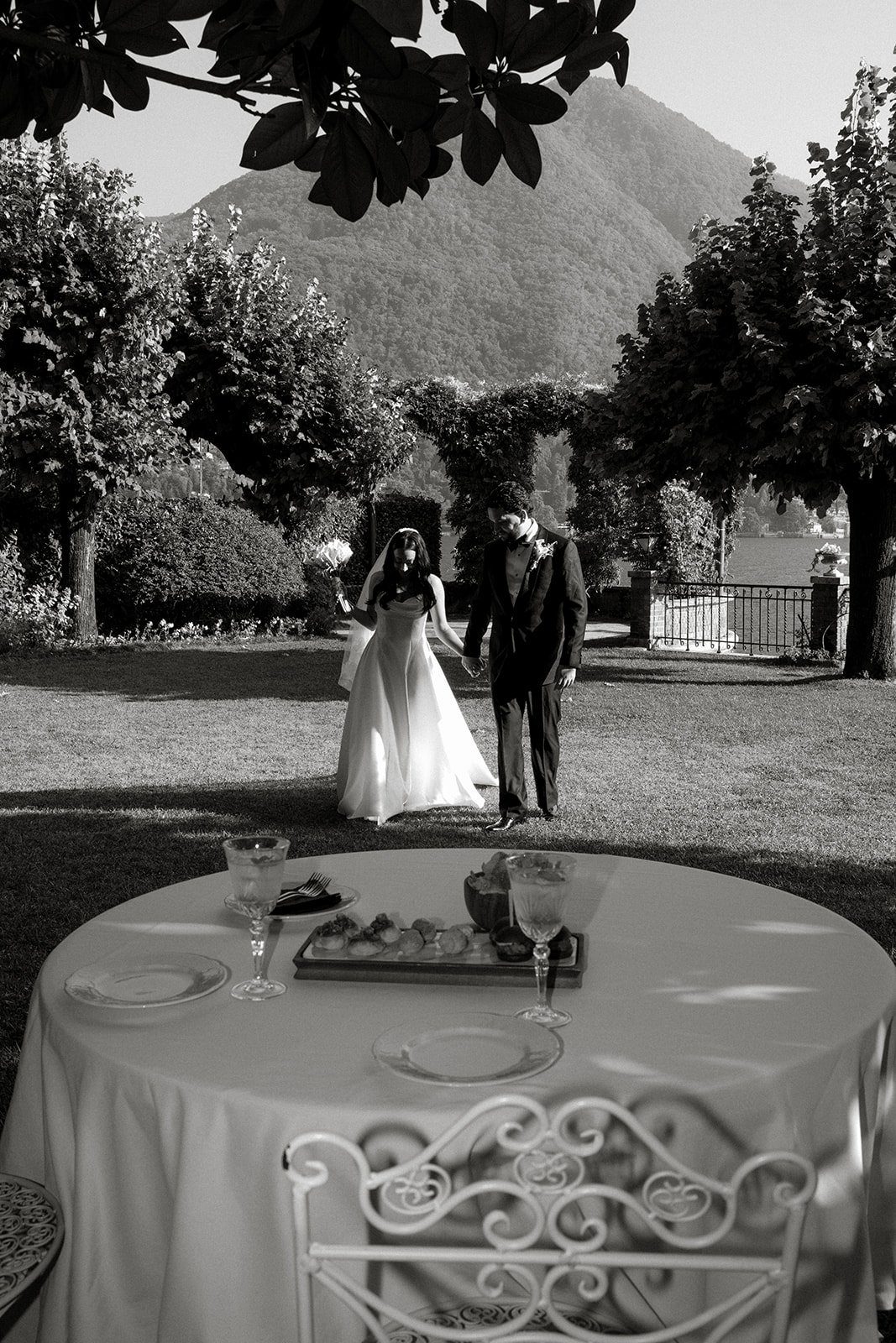 A black and white view of an outdoor dinner table in the garden at Villa Noseda