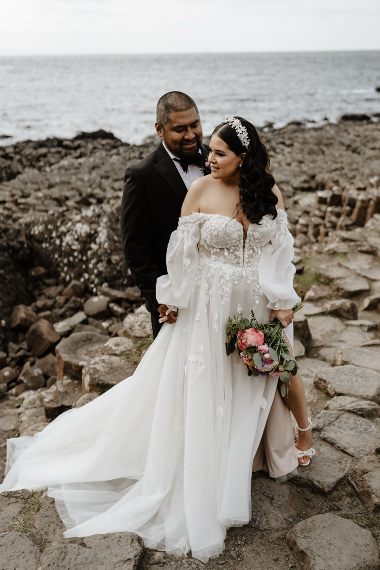 Elope on a clifftop field facing Dunluce Castle, Northern Ireland, already designed elopement in Ireland