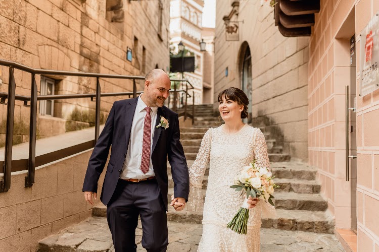A couple walking down a stone staircase lane in the village of Poble Espanyol in Barcelona