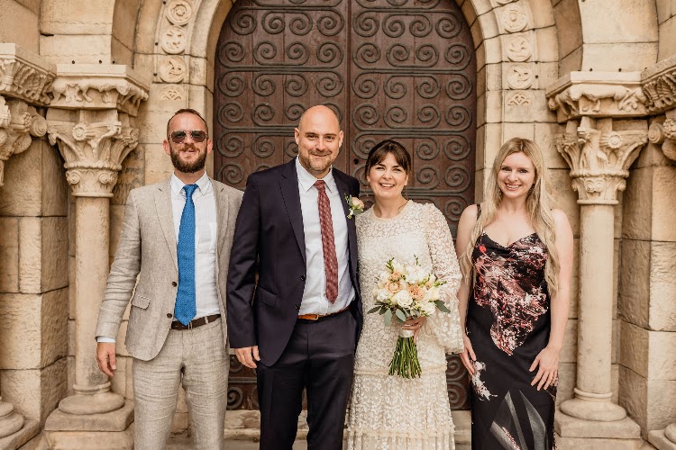 A couple with friends in front of the Romanesque doorway of the monastery at Poble Espanyol in Barcelona