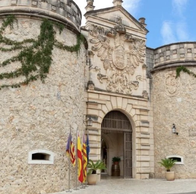 Stone towers and a carved gateway at the entrance to Poble Espanyol in Barcelona
