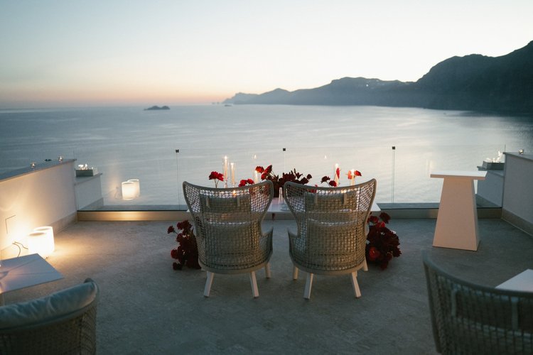 A table for two set on a terrace at sunset