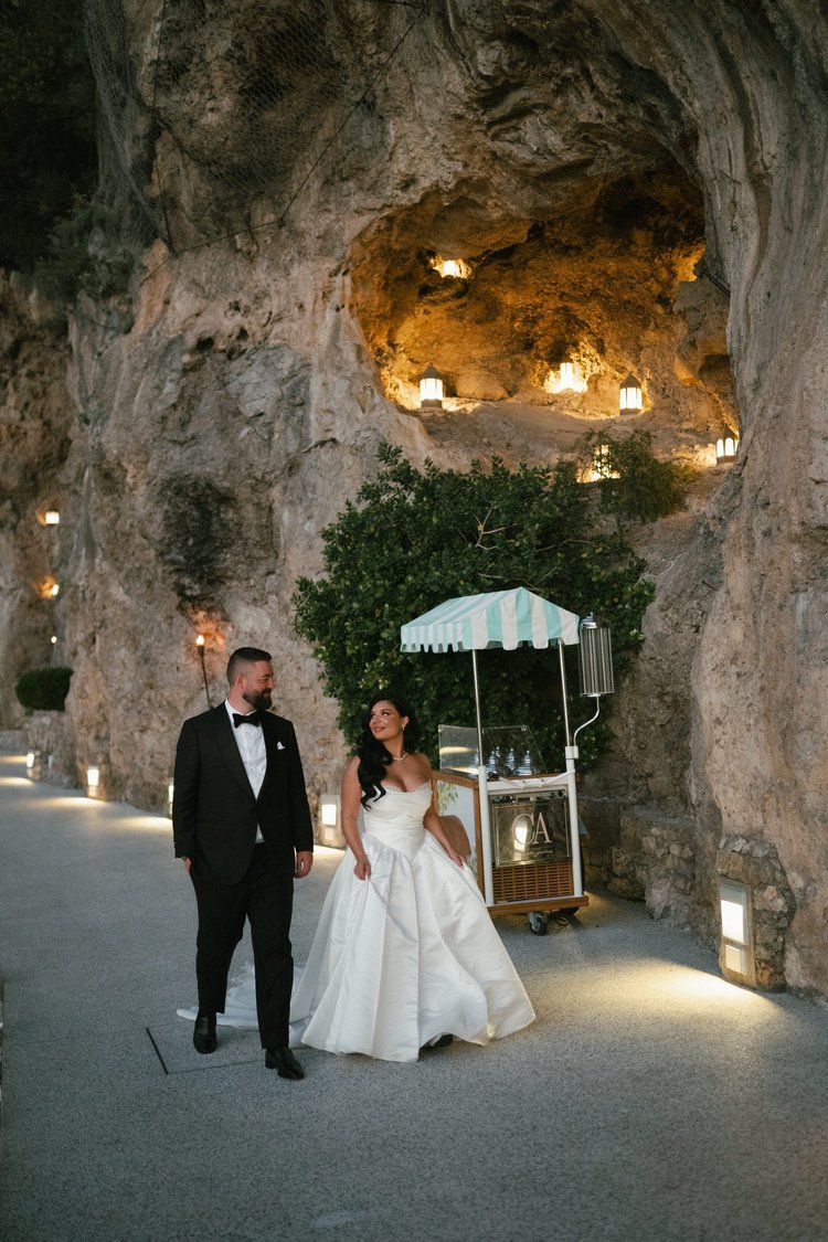 A couple in the lit grotto at night