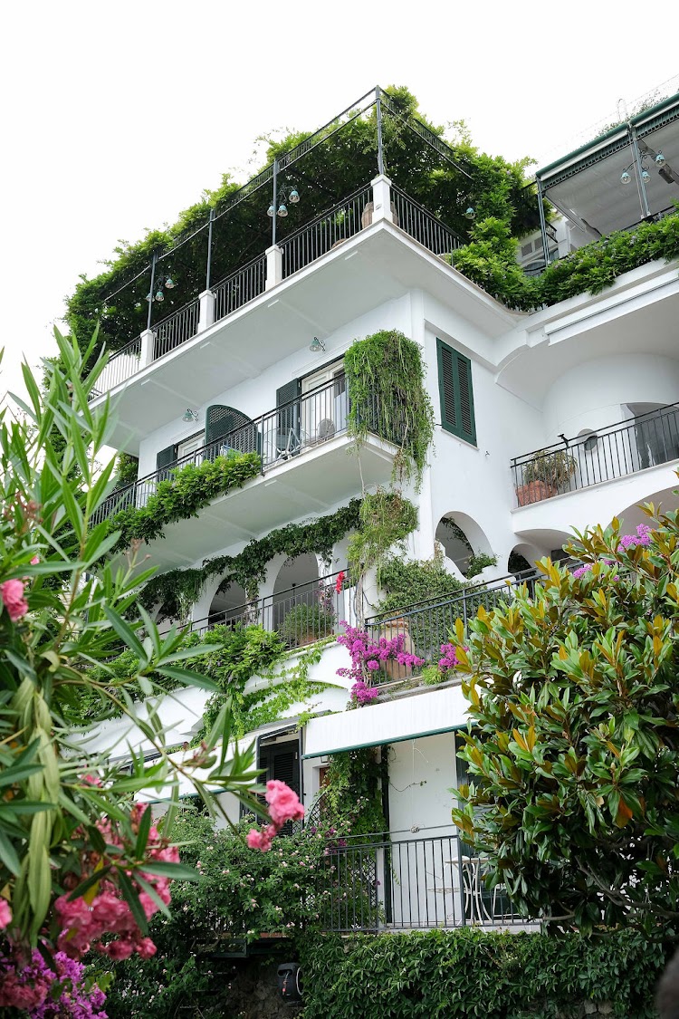 White terraced facade of Hotel Santa Caterina with climbing greenery on the Amalfi Coast