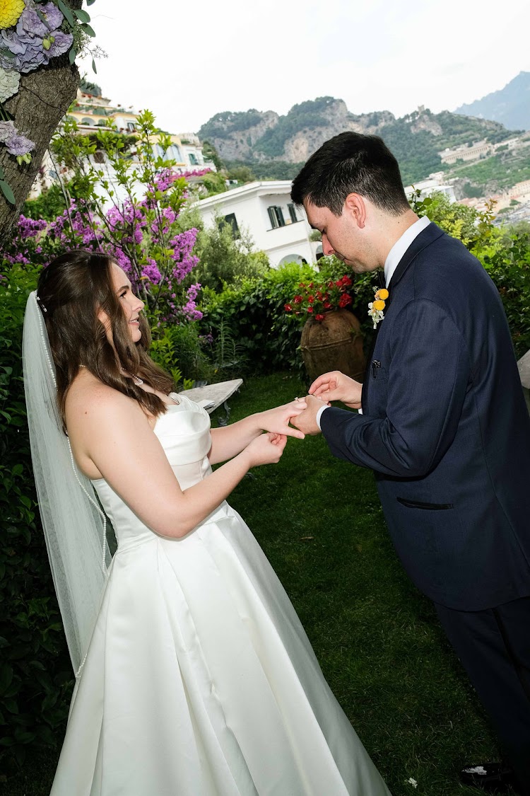 Couple exchanging rings in the garden of Hotel Santa Caterina, Amalfi Coast