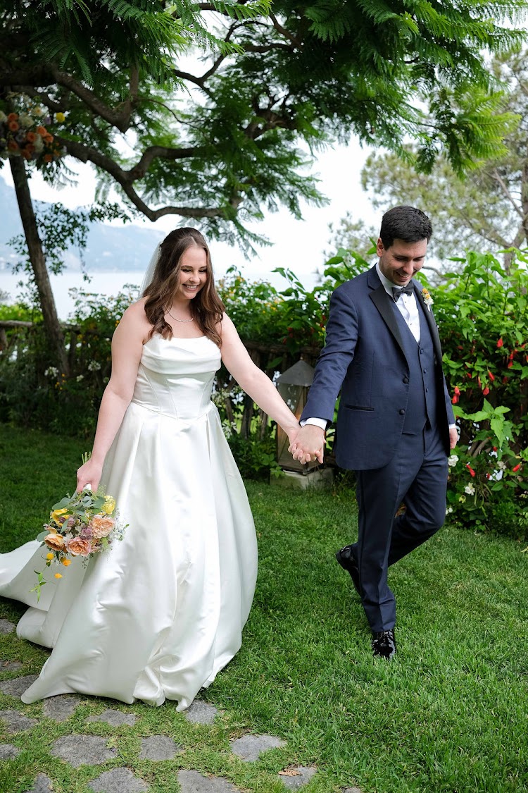 Couple walking hand in hand across the lawn at Hotel Santa Caterina, Amalfi Coast