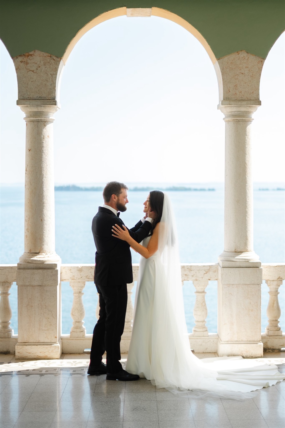 A couple embracing under the arches of Villa del Sogno on Lake Garda