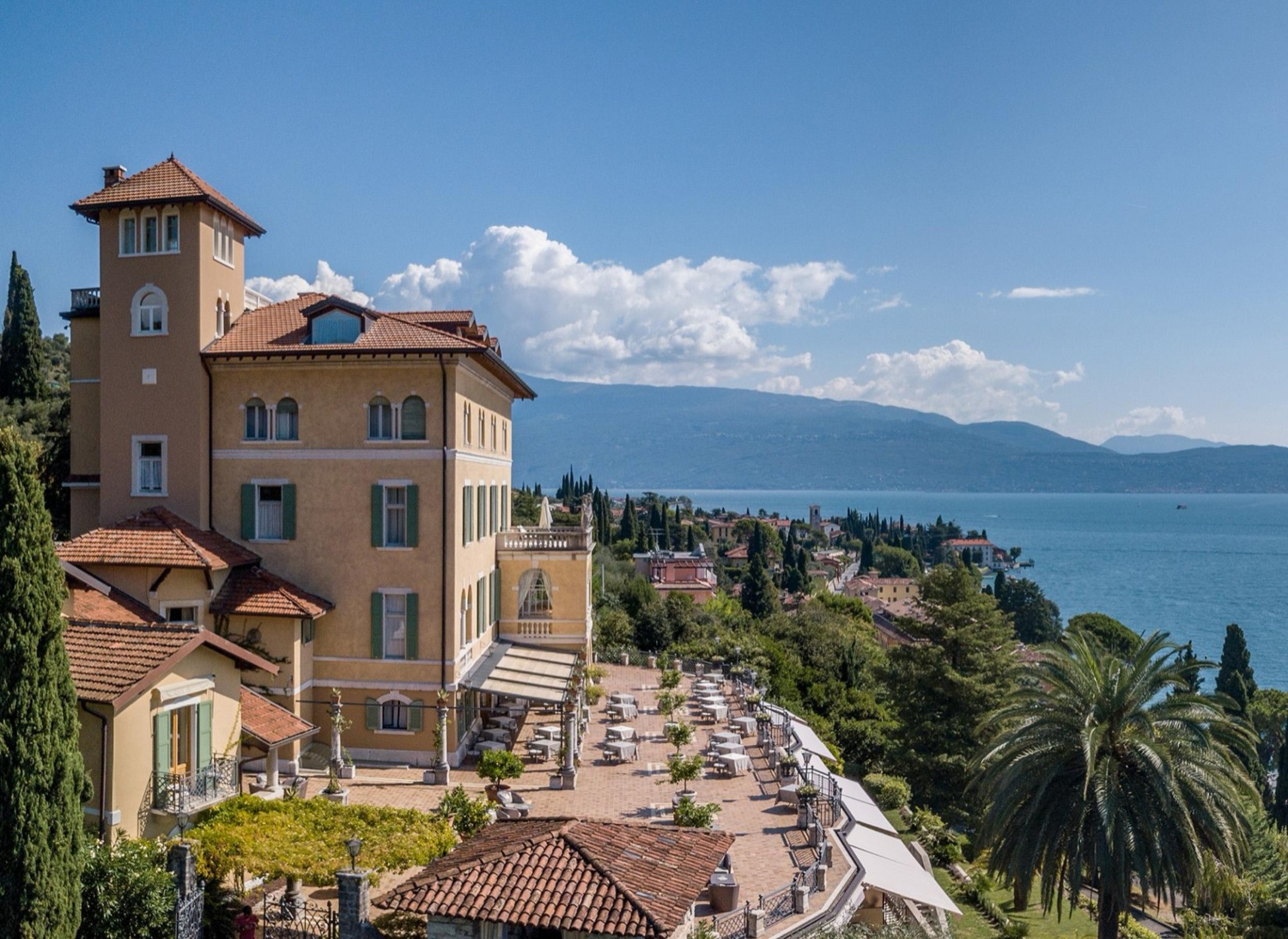 Villa del Sogno, a five-star hotel on Lake Garda, with its yellow facade, terraces and the lake beyond