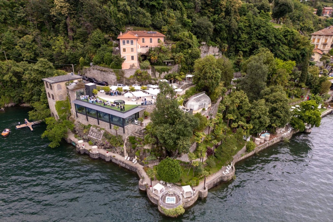 Aerial view of Villa Porta, a lakeside hotel with a terrace and gardens on the shore of Lake Maggiore, Italy